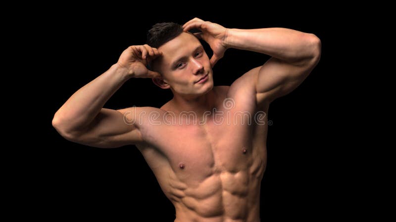 Muscular model young man on dark background. Fashion portrait of strong brutal guy with trendy hairstyle. naked stock images Muscular model young man on dark background. Fashion portrait of strong brutal guy with trendy hairstyle. naked stock images