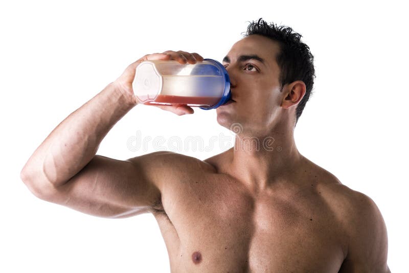 Shirtless young man drinking protein shake in gym Photograph by