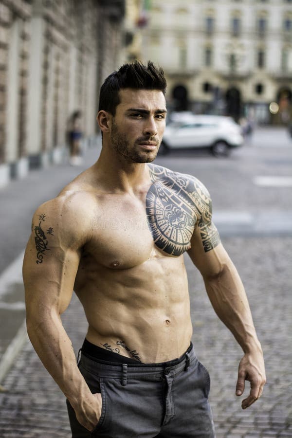 Studio portrait of handsome muscular shirtless male fitness model with  tattoo on his chest. Stock Photo | Adobe Stock