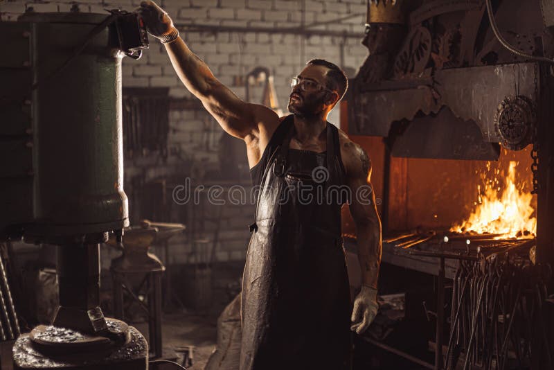 Skillful blacksmith at work place royalty free stock images