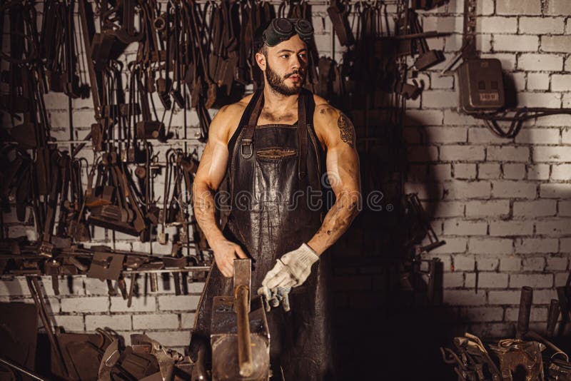 Skillful blacksmith at work place royalty free stock images
