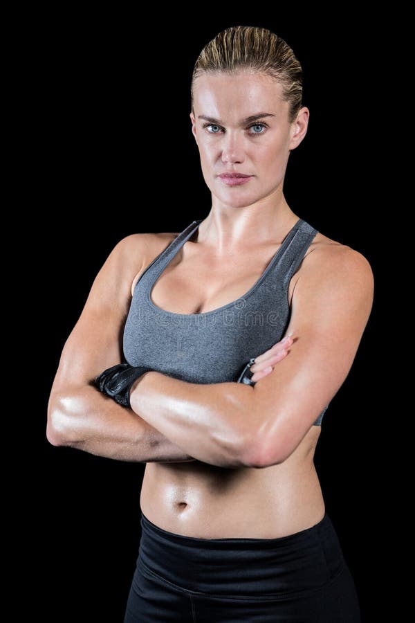 Muscular sporty lady posing with arms crossed Stock Photo by