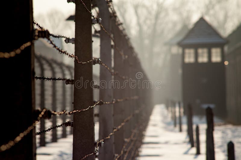 Museum Auschwitz - Holocaust Memorial Museum. Anniversary Concentration Camp Liberation Barbed wire around a concentration camp. Shed guard in the background. Museum Auschwitz - Holocaust Memorial Museum. Anniversary Concentration Camp Liberation Barbed wire around a concentration camp. Shed guard in the background.