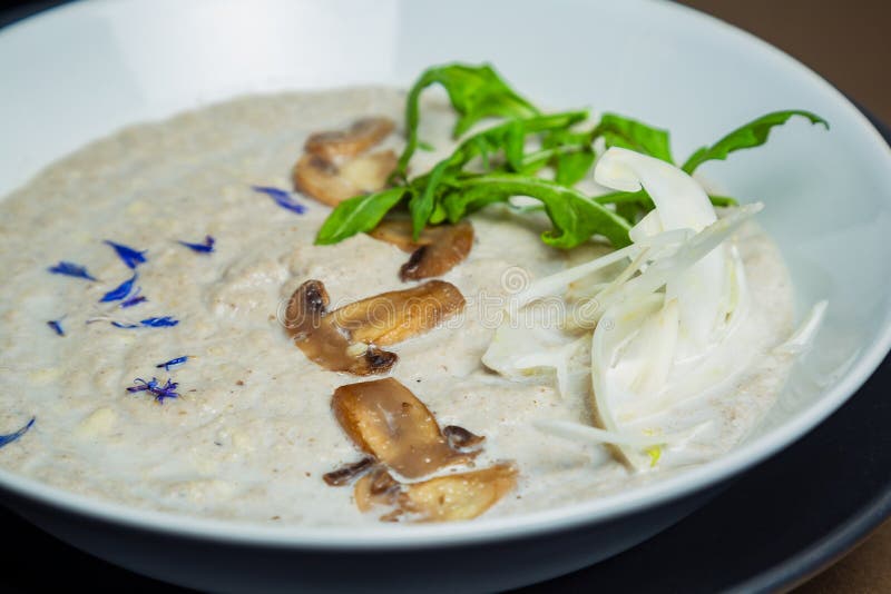 Mushroom Cream Soup with Black Truffle in a Ceramic White Bowl Stock