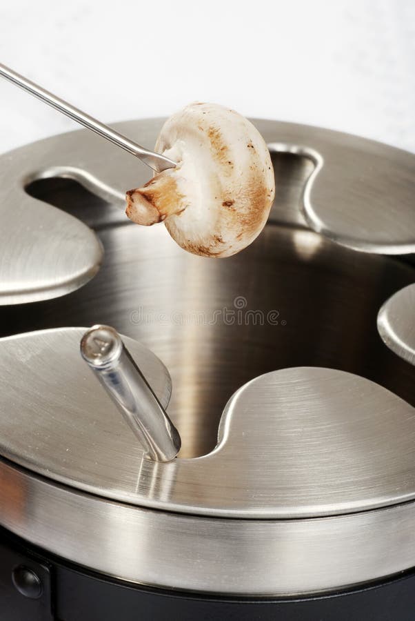 Mushroom on fondue fork stock image. Image of dish, cooking 13605945