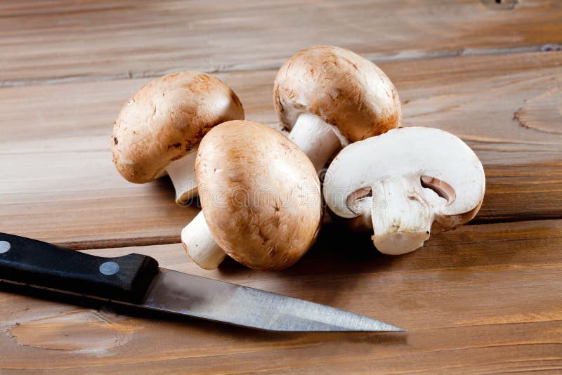 Mushrooms on wood, knive, chopped