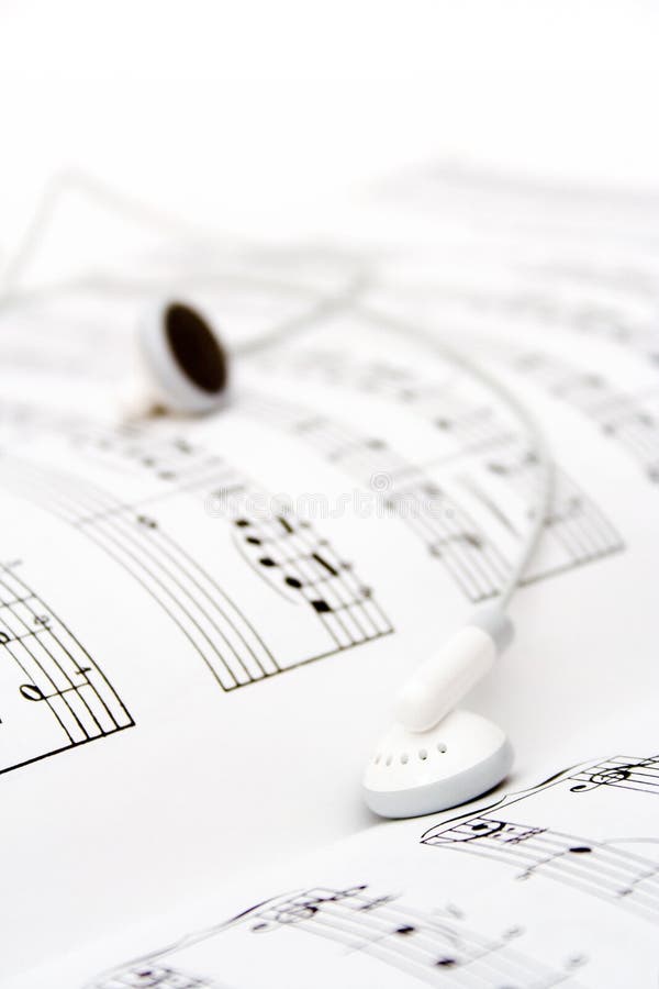 White earbuds on book of musical notes