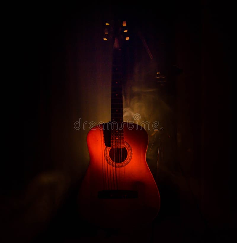Music Concept. Acoustic Guitar On A Dark Background Under Beam Of Light ...