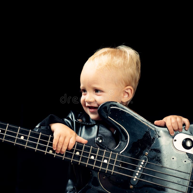 Music is fun. Small musician. Little rock star. Child boy with guitar. Little guitarist in rocker jacket. Rock style