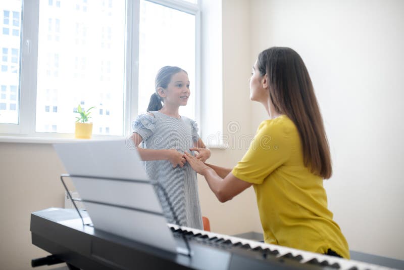 Girl and her teacher communicating at the lesson