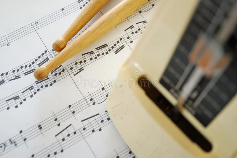 Music score, drum sticks and metronome