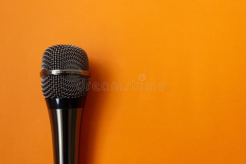Musical mycraphone on an orange background stock photos