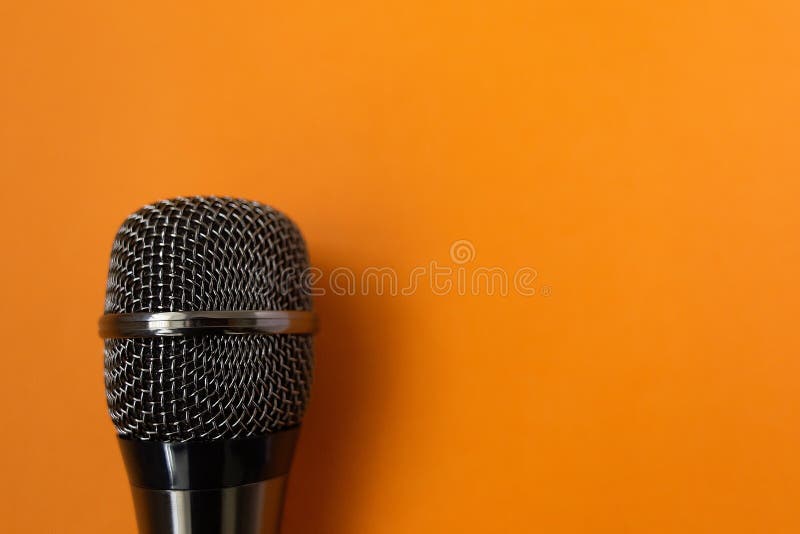 Musical mycraphone on an orange background stock photo