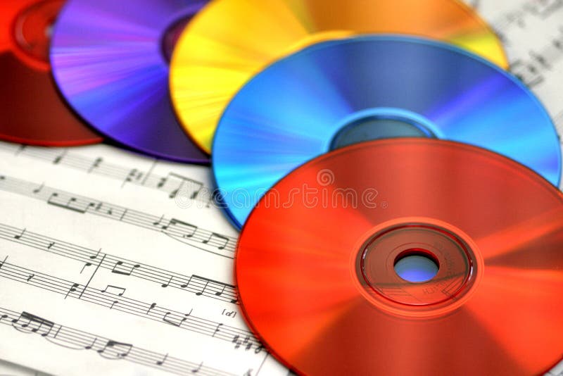 A colorful array of CDs on sheet music is an eye-catching way to illustrate the concept of copying music onto CDs, listening to music, playing and recording music, making music and more. Colorful musical notes stock images, royalty-free photos and pictures
