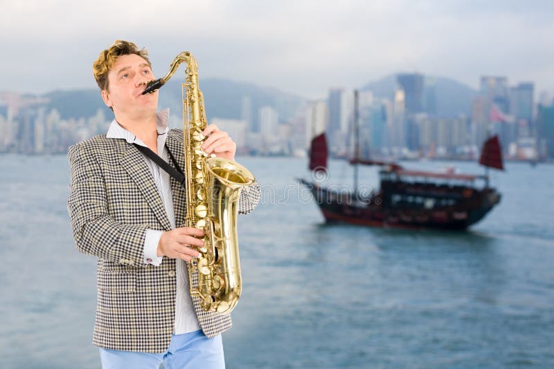 Musician in the Background of Hong Kong. Stock Photo Image of