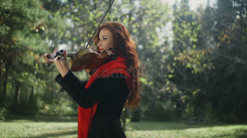 A musician with a bright appearance. Playing the violin.