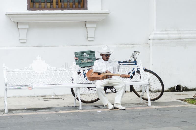 Musician dressing with traditional jarocho clothes resting on a bench royalty free stock photos Musician dressing with traditional jarocho clothes resting on a bench royalty free stock photos