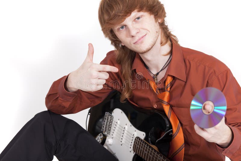 Musician with guitar selling compact disc stock photography