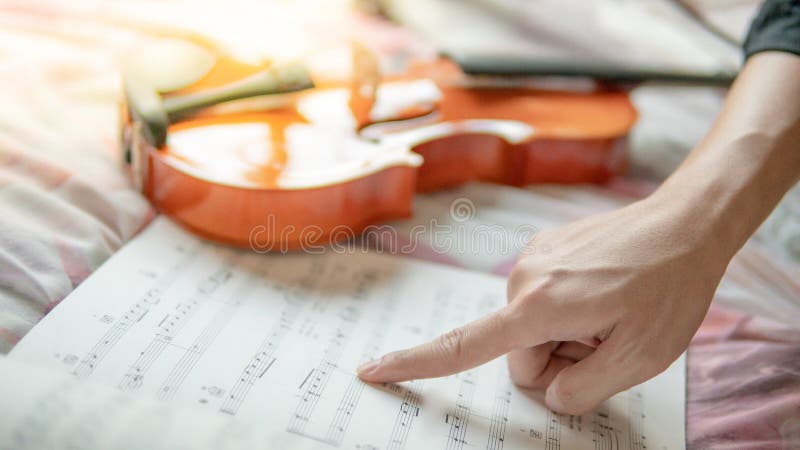 Violin And The Sheet Of Music Note On The Bed Stock Image