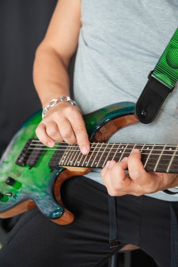 Musician hands skillfully playing electric guitar strings stock image