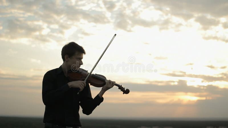 Musician playing violin on the roof, classic music.