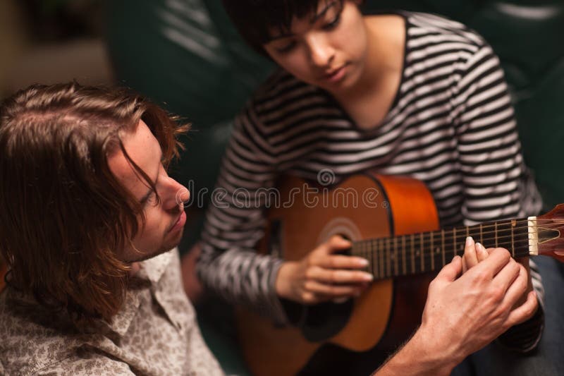 Musician Teaches Female Student To Play Guitar