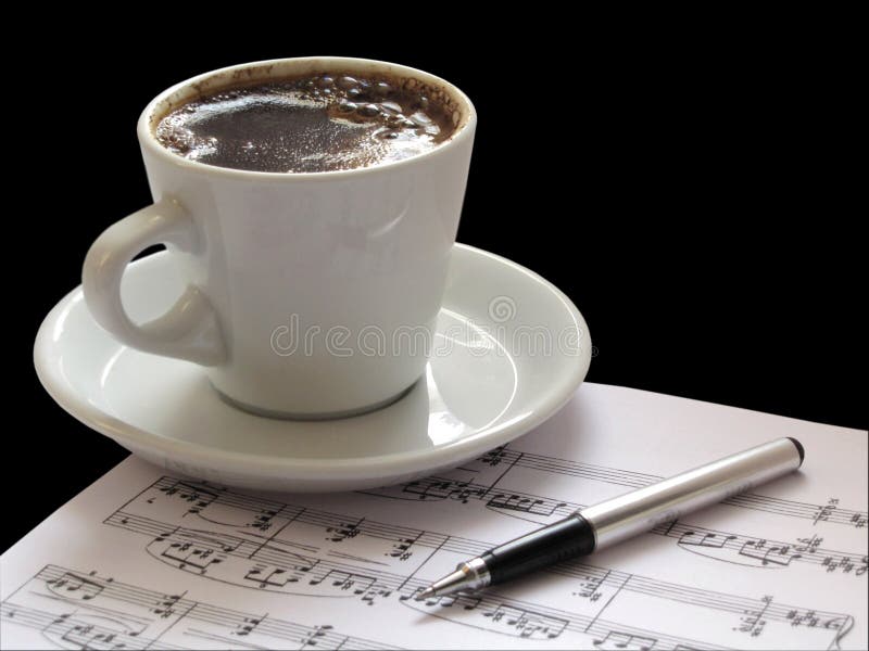 Close up musical notation on a staff with cup of coffee and ballpen. Close up musical notation on a staff with cup of coffee and ballpen