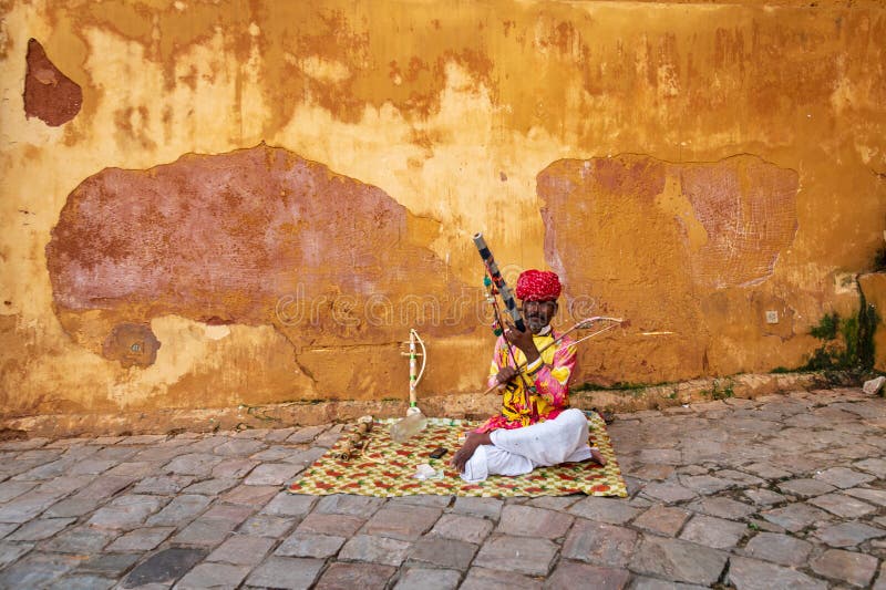 Musician outside the Moon Gate of the Amber, Fort Amer , Rajasthan, India. A narrow 4WD road leads up to the entrance gate, known as the Suraj Pol (Sun Gate) of the fort. It is now considered much more ethical for tourists to take jeep rides up to the fort, instead of riding the elephants. Amer Fort or Amber Fort is a fort located in Amer, Rajasthan, India. Amer is a town with an area of 4 square kilometres (1.5 sq mi) located 11 kilometres (6.8 mi) from Jaipur, the capital of Rajasthan. Located high on a hill, it is the principal tourist attraction in Jaipur. Amer Fort is known for its artistic style elements. With its large ramparts and series of gates and cobbled paths, the fort overlooks Maota Lake which is the main source of water for the Amer Palace. Musician outside the Moon Gate of the Amber, Fort Amer , Rajasthan, India. A narrow 4WD road leads up to the entrance gate, known as the Suraj Pol (Sun Gate) of the fort. It is now considered much more ethical for tourists to take jeep rides up to the fort, instead of riding the elephants. Amer Fort or Amber Fort is a fort located in Amer, Rajasthan, India. Amer is a town with an area of 4 square kilometres (1.5 sq mi) located 11 kilometres (6.8 mi) from Jaipur, the capital of Rajasthan. Located high on a hill, it is the principal tourist attraction in Jaipur. Amer Fort is known for its artistic style elements. With its large ramparts and series of gates and cobbled paths, the fort overlooks Maota Lake which is the main source of water for the Amer Palace.