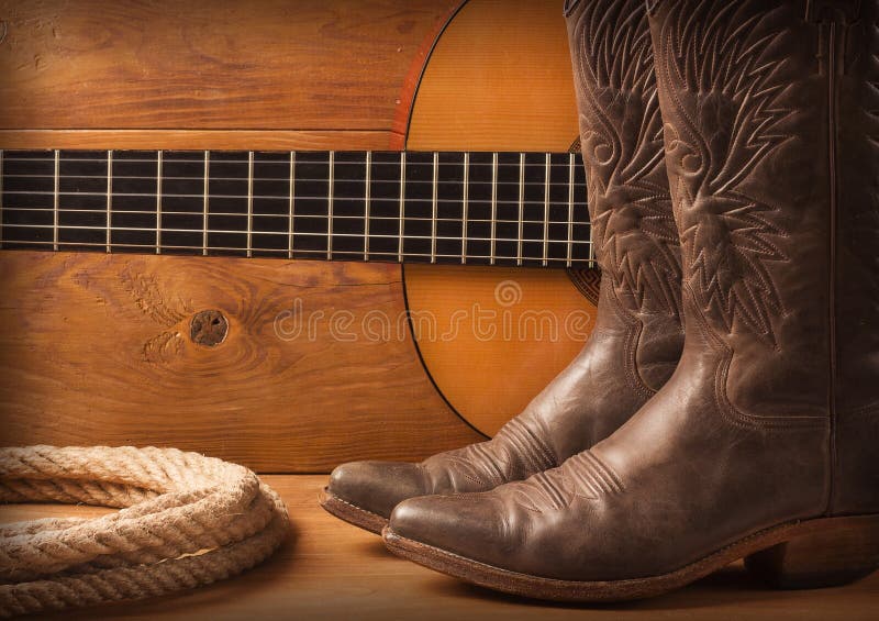 Musique country américaine avec des chaussures de guitare et de cowboy sur le texte en bois