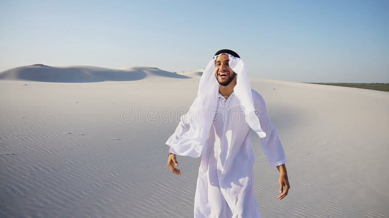 Muslim Arabian UAE Sheikh architect sitting with laptop on sand