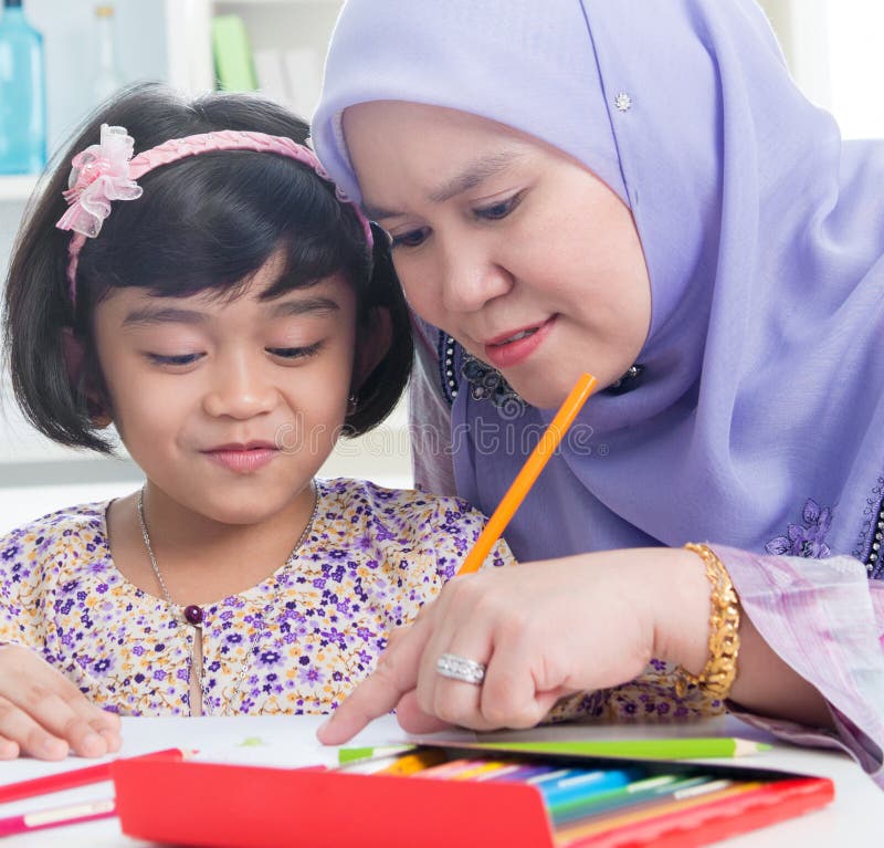 Muslim family drawing picture at home.