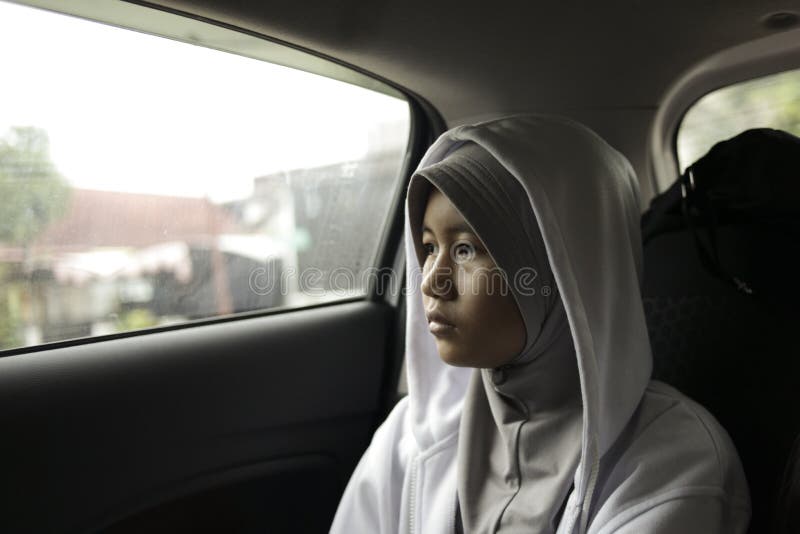 Portrait of young Asian muslim girl in car, lonely sad depression concept, bored in trip indonesian malaysian arab automobile person woman travel transportation drive tired stressed vehicle female people depressed lifestyle face road unhappy problem sitting window alone looking upset rest traffic thinking fatigue sleepy expression emotion annoyed journey disappointed frustrated pensive. Portrait of young Asian muslim girl in car, lonely sad depression concept, bored in trip indonesian malaysian arab automobile person woman travel transportation drive tired stressed vehicle female people depressed lifestyle face road unhappy problem sitting window alone looking upset rest traffic thinking fatigue sleepy expression emotion annoyed journey disappointed frustrated pensive