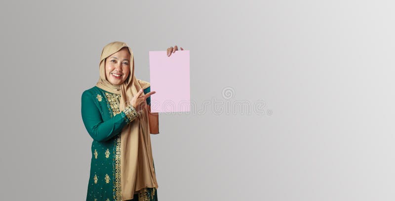 Muslim Woman Holding a Blank Pink Paper for Message or Design arkivfoto