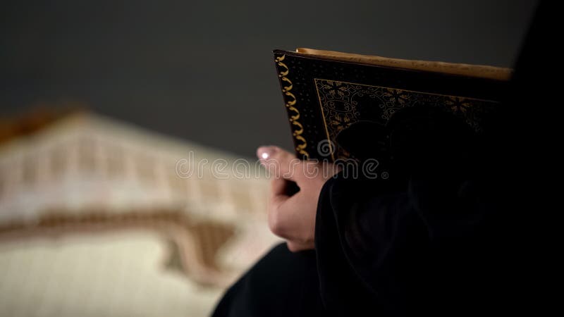 Muslim woman reading quran, sitting on ground in mosque, holy guidance book royalty free stock photos Muslim woman reading quran, sitting on ground in mosque, holy guidance book royalty free stock photos