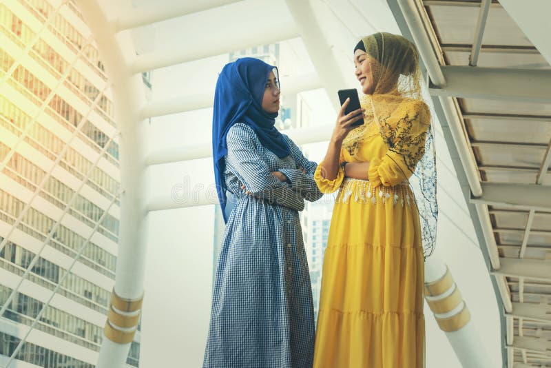 Muslim Women Messaging on a Mobile Phone Stock Photo - Image of hijab ...