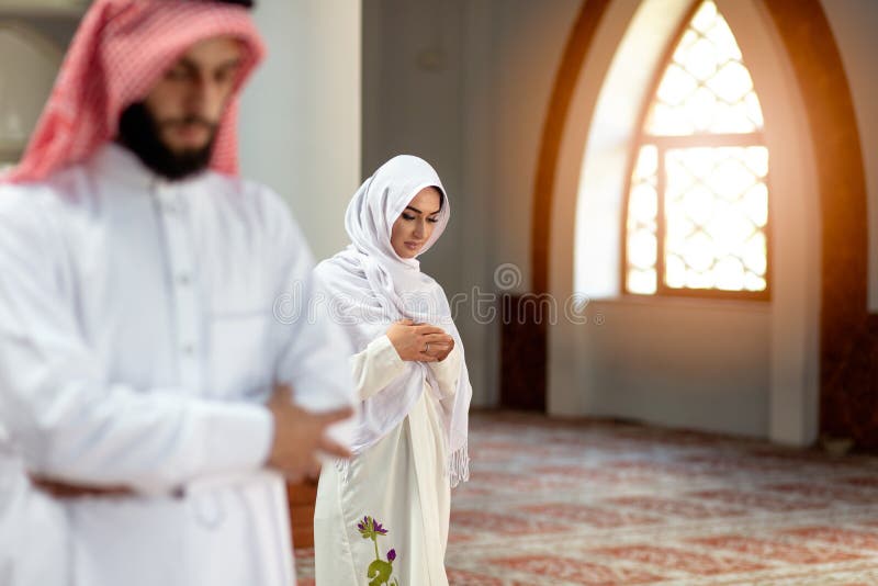 Muslimsk be man och kvinna i moské royaltyfri foto Muslimsk be man och kvinna i moské royaltyfri foto