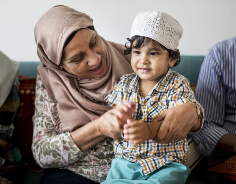 Muslimsk familj som kopplar av i hemmet royaltyfri foto Muslimsk familj som kopplar av i hemmet royaltyfri foto