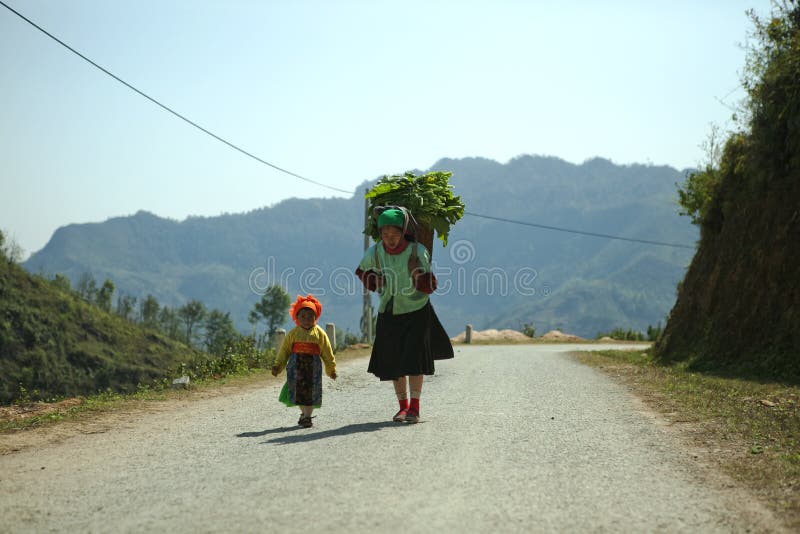 Ethnic minority mom and daughter near Van market, Ha Giang province, Vietnam. Ha Giang is one of the six poorest provinces of Vietnam. Ha Giang is a famous tourist destination in Vietnam. Photo taken on: 03 May 2011. Ethnic minority mom and daughter near Van market, Ha Giang province, Vietnam. Ha Giang is one of the six poorest provinces of Vietnam. Ha Giang is a famous tourist destination in Vietnam. Photo taken on: 03 May 2011