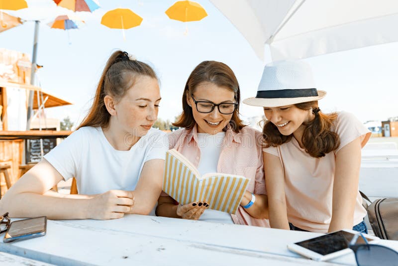 Mutter- und Tochterjugendliche haben Spaß, die Unterhaltung, Blick und gelesenes lustiges Buch Kommunikation des Elternteils und lizenzfreie stockfotografie Mutter- und Tochterjugendliche haben Spaß, die Unterhaltung, Blick und gelesenes lustiges Buch Kommunikation des Elternteils und lizenzfreie stockfotografie