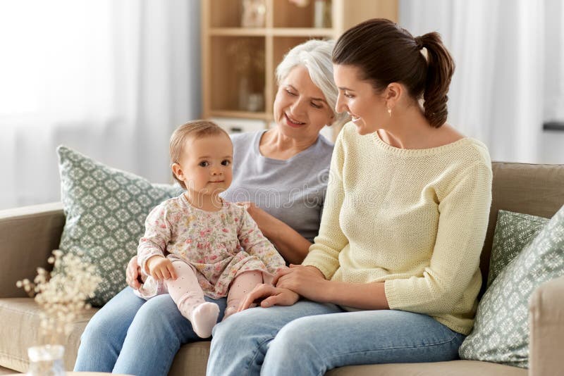 Muttertochter und -großmutter auf Sofa zu Hause stockfotografie
