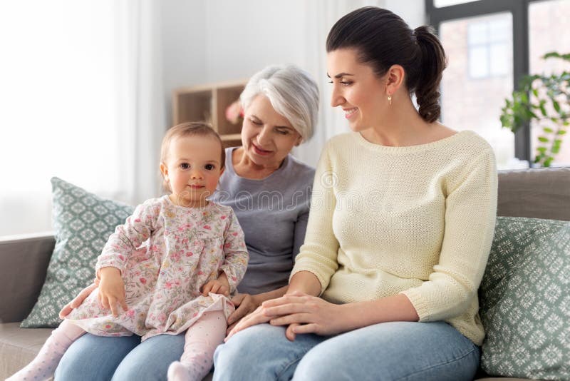Muttertochter und -großmutter auf Sofa zu Hause stockfoto