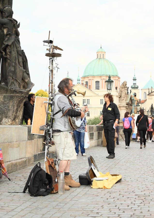 Musician with strange music instrument on Charles Bridge (Prague, Czech Republic). Musician with strange music instrument on Charles Bridge (Prague, Czech Republic)