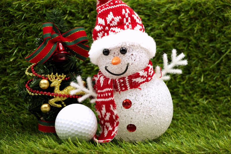 Snowman with golf ball and ornament on grass background. Snowman with golf ball and ornament on grass background