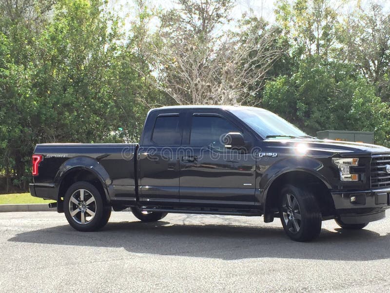 Big Black Truck in a Car Parking Lot for Big Cars Editorial Photography