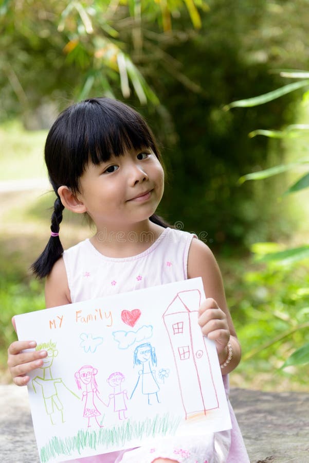 Little child shows drawing of her family member. Little child shows drawing of her family member