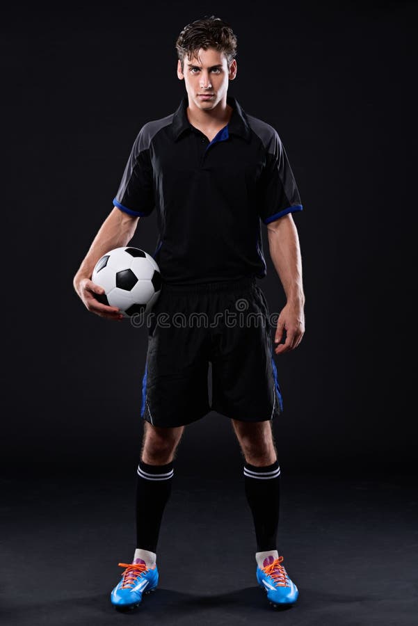 My only goal is to stop yours. Portrait of a handsome soccer playing holding a ball. stock images