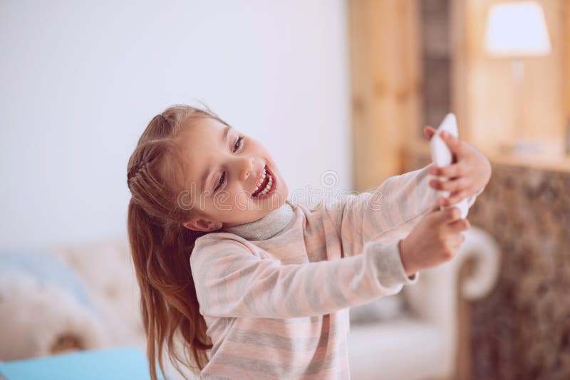 Delighted happy girl taking selfie