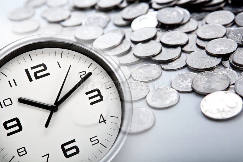 White clock face and Russian ruble coins closeup. White clock face and Russian ruble coins closeup