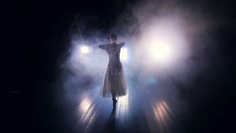 A thick fog surrounds a dancing ballerina.