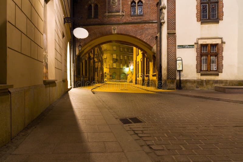 Mysterious narrow alley with lanterns in Krakow stock photos Mysterious narrow alley with lanterns in Krakow stock photos